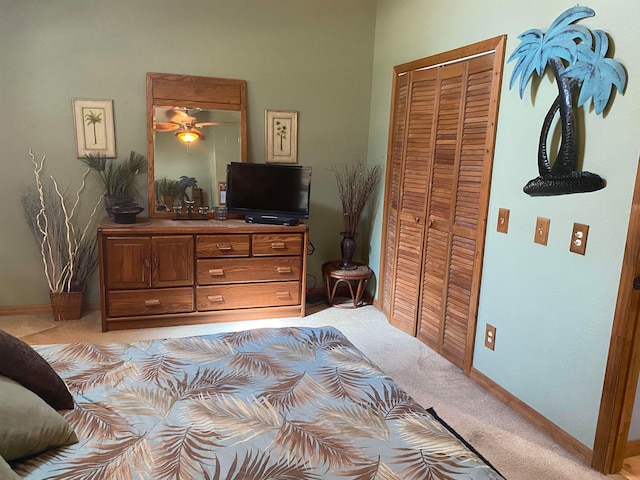 bedroom featuring light colored carpet and a closet