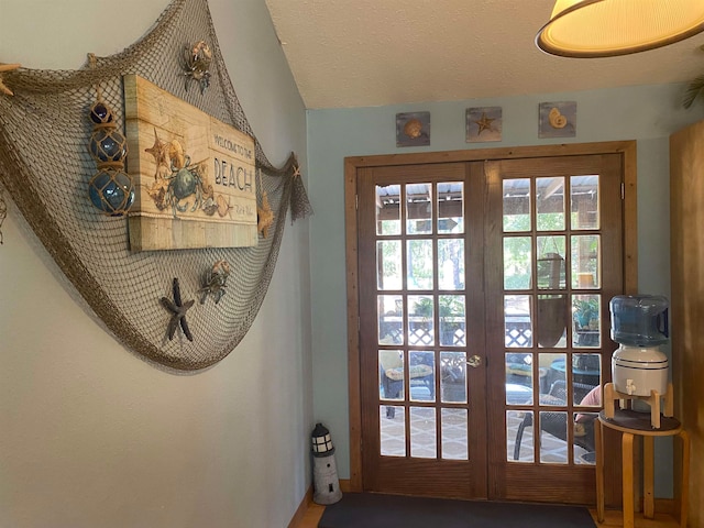 doorway to outside with french doors and a textured ceiling