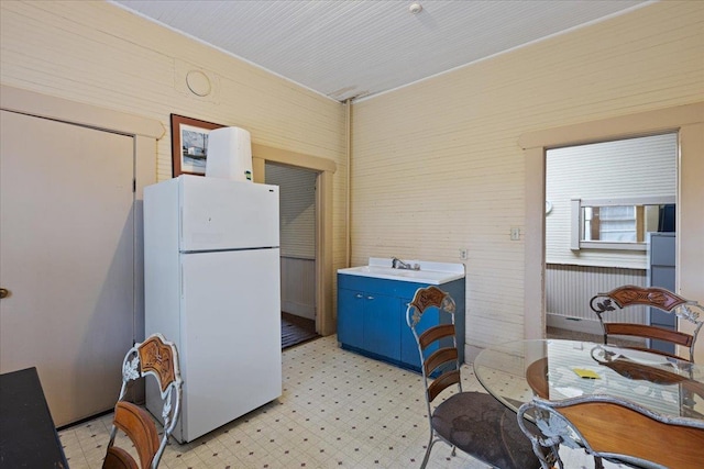 315 W Green St, Perry, FL 32347 - kitchen featuring freestanding refrigerator, light floors, and blue cabinets
