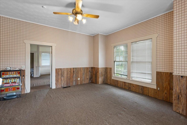 315 W Green St, Perry, FL 32347 - unfurnished room featuring wainscoting, ornamental molding, wallpapered walls, healthy amount of natural light, and carpet