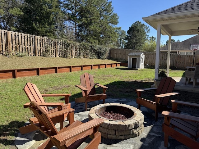 view of patio / terrace with a storage unit and a fire pit