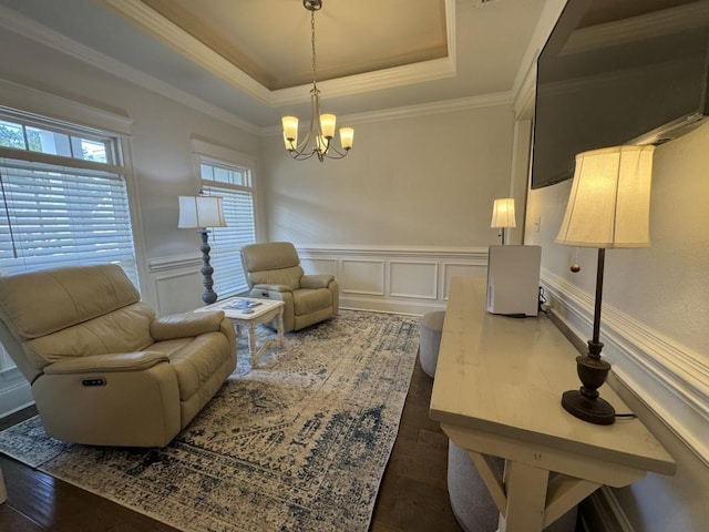 sitting room with a notable chandelier, crown molding, a raised ceiling, and dark hardwood / wood-style floors