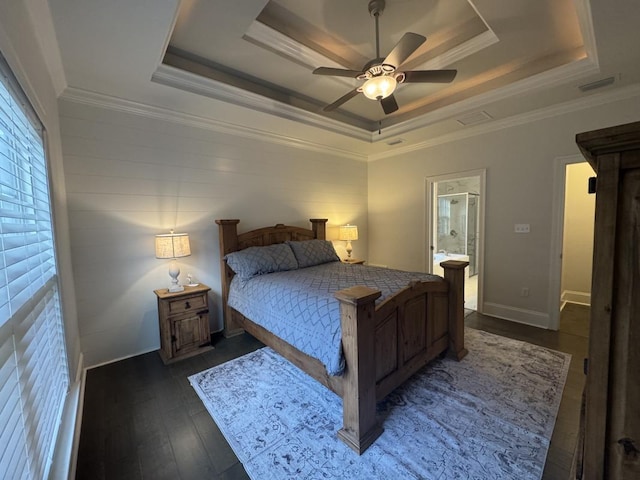 bedroom with a tray ceiling, ornamental molding, dark hardwood / wood-style floors, and ceiling fan