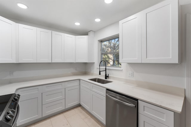 kitchen featuring sink, light tile patterned flooring, white cabinets, and appliances with stainless steel finishes