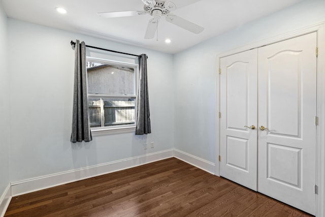 unfurnished bedroom with dark wood-type flooring, recessed lighting, a closet, and baseboards