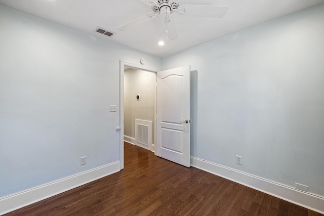 spare room with visible vents, dark wood finished floors, baseboards, and ceiling fan