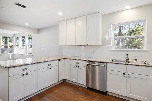 kitchen featuring visible vents, dishwasher, light stone countertops, white cabinetry, and a sink