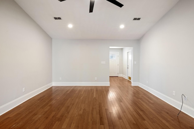 spare room with visible vents, ceiling fan, baseboards, and wood finished floors