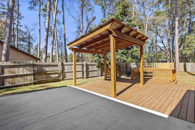 deck featuring a fenced backyard and a pergola