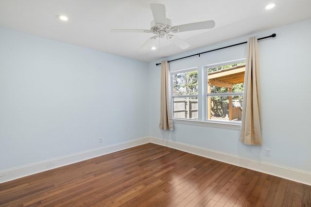 spare room with recessed lighting, baseboards, and wood finished floors