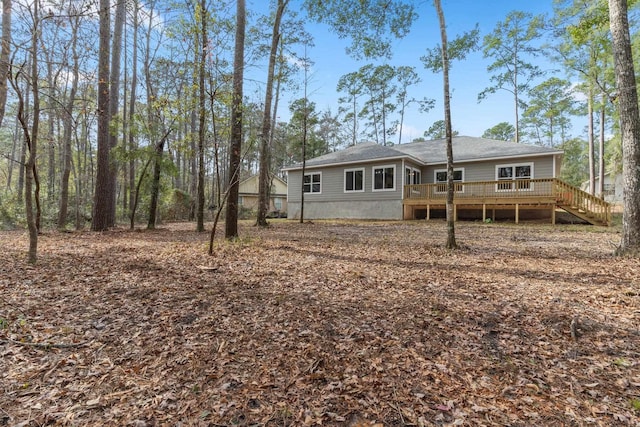 rear view of house featuring a deck