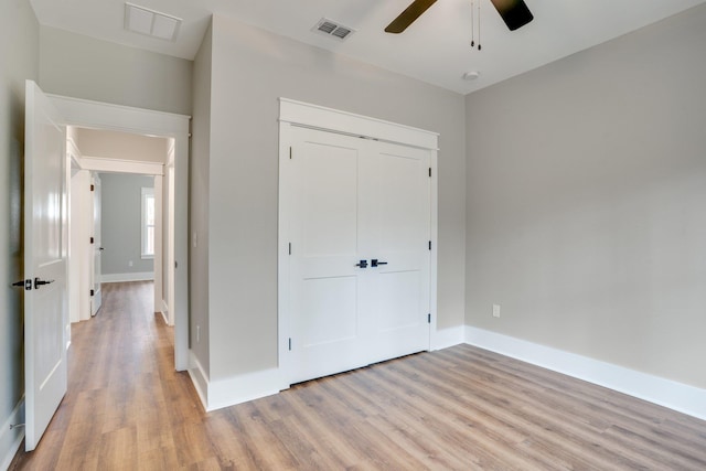 unfurnished bedroom featuring a closet, ceiling fan, and light hardwood / wood-style flooring