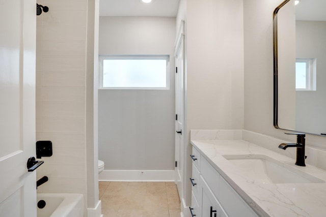 full bathroom featuring toilet, tiled shower / bath, tile patterned floors, and vanity