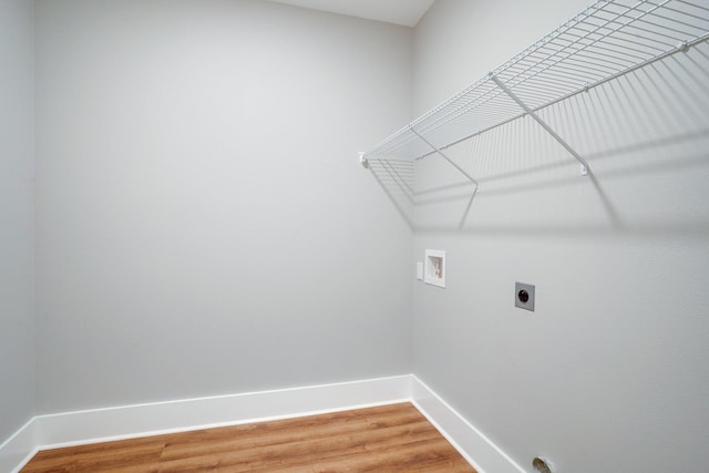 washroom featuring hookup for an electric dryer, hardwood / wood-style floors, and washer hookup