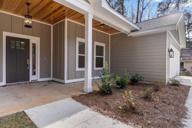 view of exterior entry with covered porch