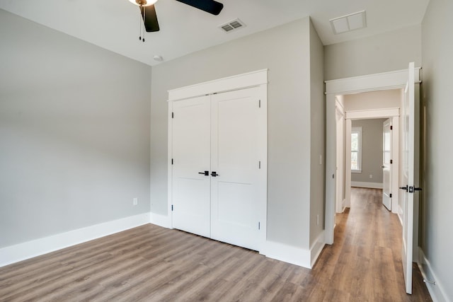 unfurnished bedroom featuring light wood-type flooring, a closet, and ceiling fan