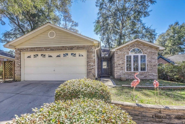 ranch-style home with brick siding, driveway, and an attached garage