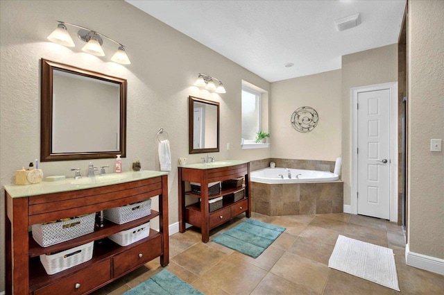 459 Oakwood Trl, Crawfordville, FL 32327 - bathroom with a garden tub, two vanities, and tile patterned flooring