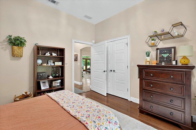 459 Oakwood Trl, Crawfordville, FL 32327 - bedroom with arched walkways, dark wood-type flooring, and a closet