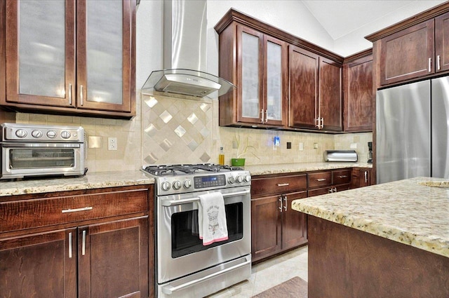 459 Oakwood Trl, Crawfordville, FL 32327 - kitchen with stainless steel appliances, wall chimney range hood, light stone countertops, glass insert cabinets, and vaulted ceiling