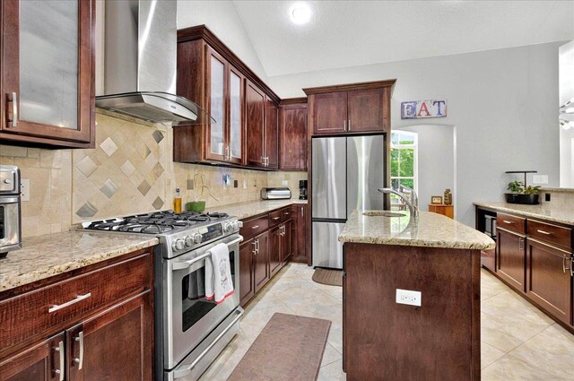 459 Oakwood Trl, Crawfordville, FL 32327 - kitchen with appliances with stainless steel finishes, wall chimney exhaust hood, a center island, backsplash, and vaulted ceiling