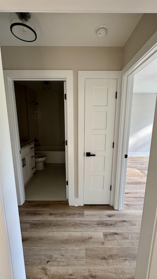 hallway with wood finished floors