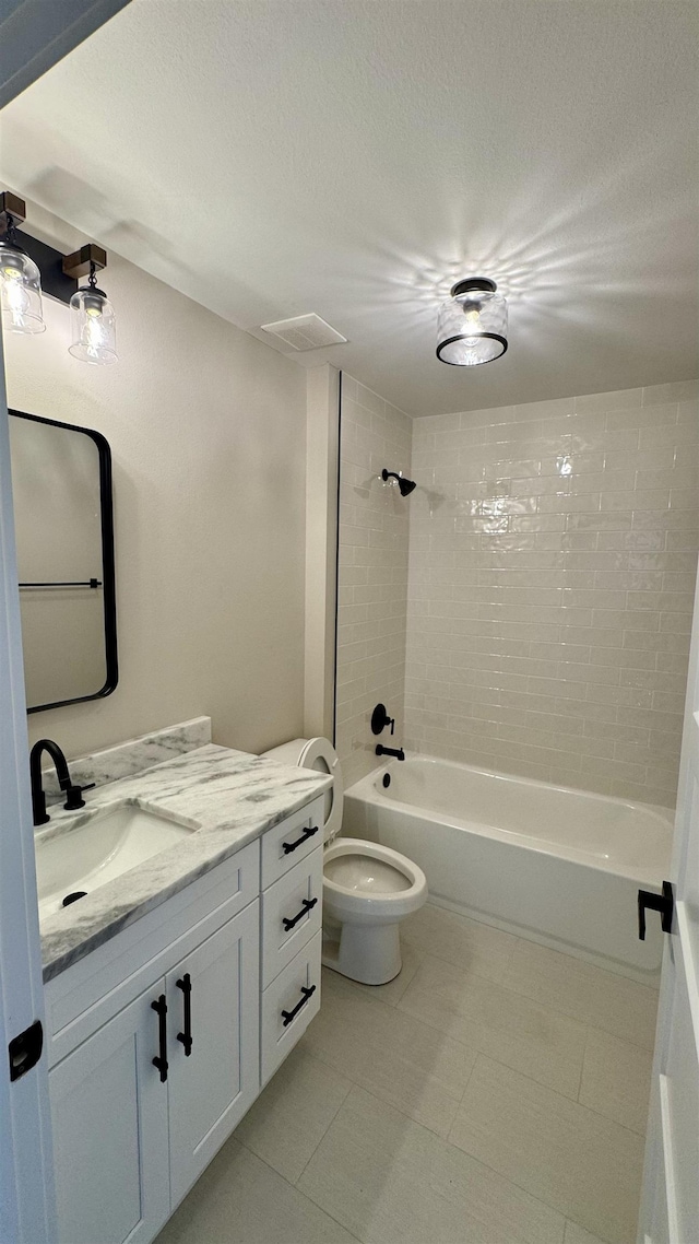 bathroom featuring vanity, shower / bath combination, and a textured ceiling