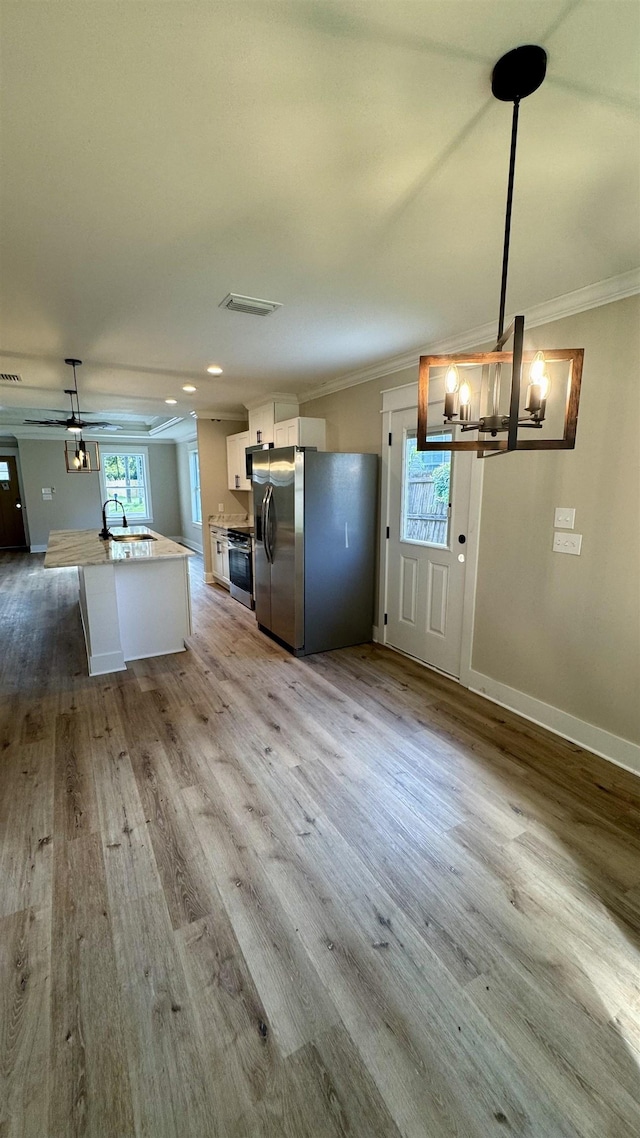 kitchen featuring stainless steel fridge with ice dispenser, a chandelier, crown molding, wood finished floors, and white cabinets