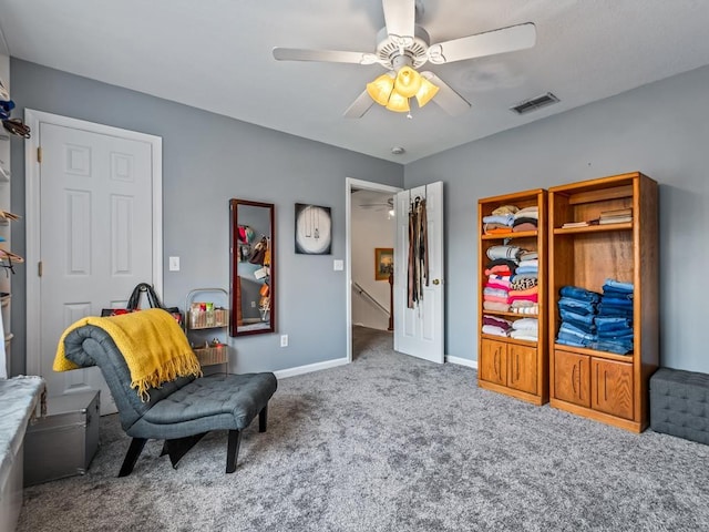 living area with ceiling fan and carpet flooring