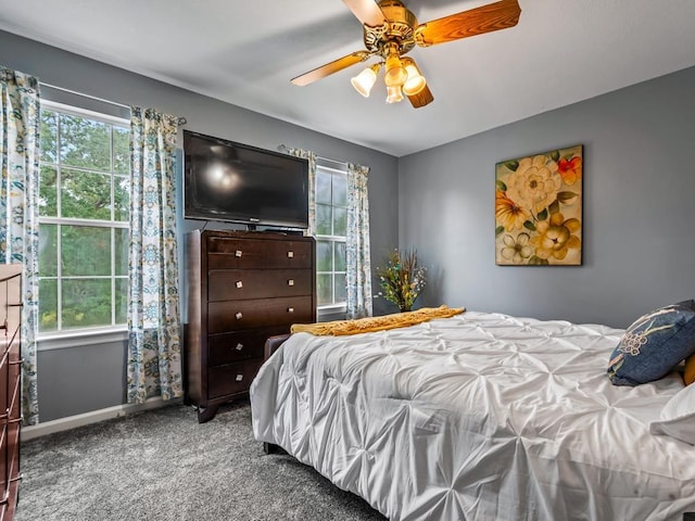 carpeted bedroom with multiple windows and ceiling fan