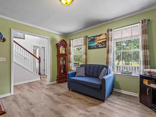 sitting room featuring crown molding and light wood-type flooring