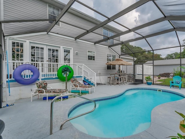 view of pool featuring a patio and glass enclosure