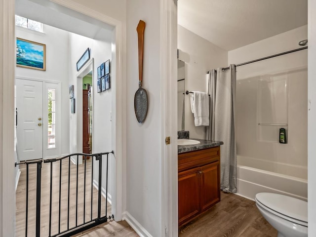 full bathroom with vanity, hardwood / wood-style flooring, toilet, and shower / bath combo