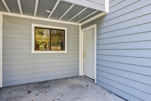 view of exterior entry featuring a patio area