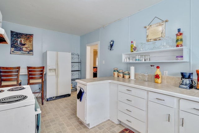 kitchen with white appliances, a peninsula, light countertops, white cabinetry, and open shelves