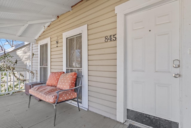 view of exterior entry featuring a porch