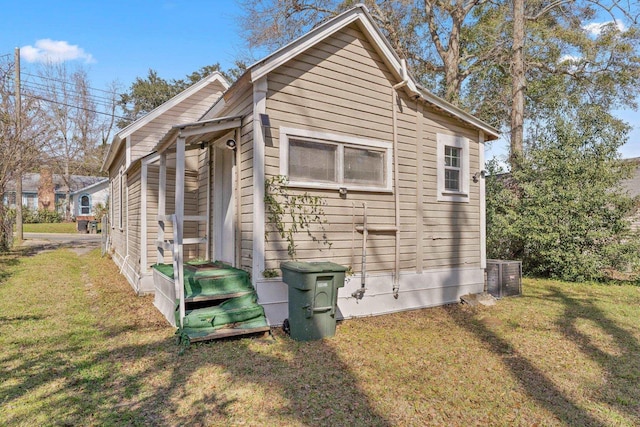 view of side of home featuring a yard