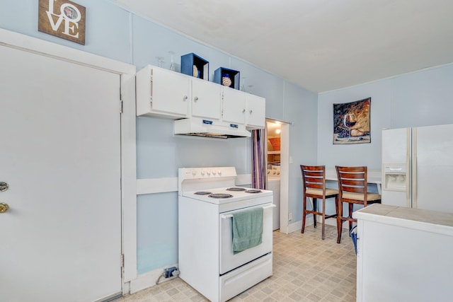 kitchen featuring light countertops, white appliances, white cabinetry, and under cabinet range hood