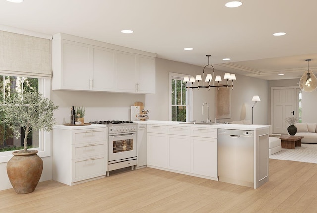 606 Hampton Ave, Tallahassee, FL 32310 - kitchen with white cabinets, gas range gas stove, hanging light fixtures, light countertops, and stainless steel dishwasher