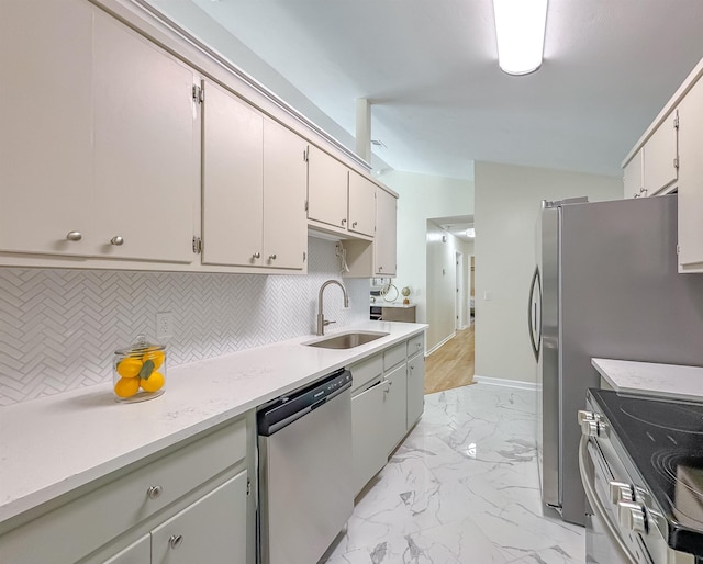 804 Medical Commons Ct, Tallahassee, FL 32310 - kitchen featuring light countertops, stainless steel appliances, decorative backsplash, marble finish floor, and a sink