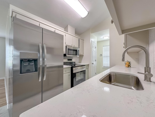 804 Medical Commons Ct, Tallahassee, FL 32310 - kitchen with a sink, appliances with stainless steel finishes, light stone counters, and vaulted ceiling