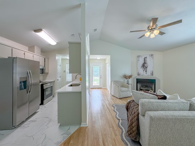 804 Medical Commons Ct, Tallahassee, FL 32310 - kitchen with light countertops, a sink, a ceiling fan, appliances with stainless steel finishes, and lofted ceiling