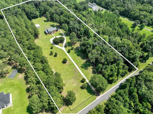 birds eye view of property featuring a view of trees