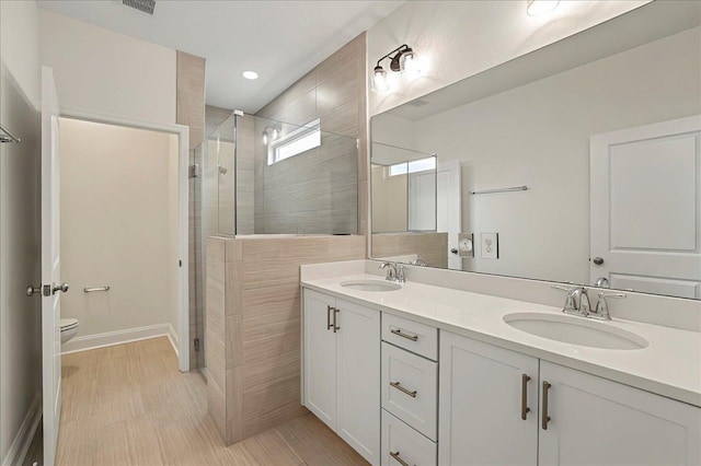 8372 Bull Headley Rd, Tallahassee, FL 32312 - bathroom featuring a shower stall, toilet, double vanity, baseboards, and recessed lighting
