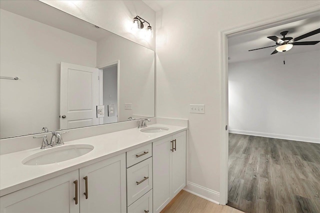 8372 Bull Headley Rd, Tallahassee, FL 32312 - bathroom with wood finished floors, a ceiling fan, double vanity, and baseboards