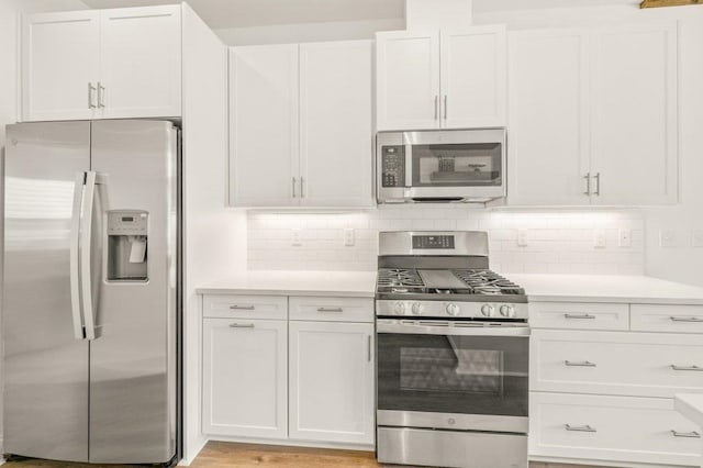 8372 Bull Headley Rd, Tallahassee, FL 32312 - kitchen with stainless steel appliances, light countertops, white cabinets, and tasteful backsplash
