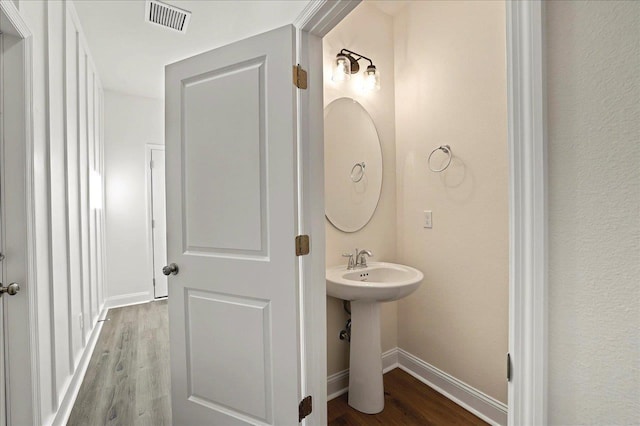 8372 Bull Headley Rd, Tallahassee, FL 32312 - bathroom featuring wood finished floors, baseboards, and a sink