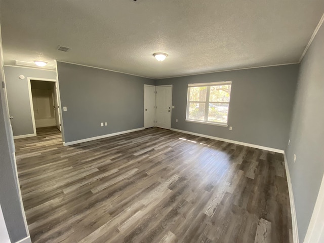 4350 Fortner Cir, Perry, FL 32347 - unfurnished room featuring dark wood-type flooring, a textured ceiling, and crown molding