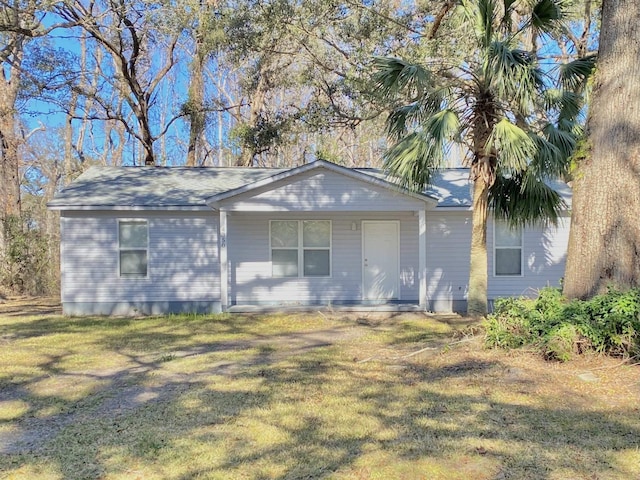 4350 Fortner Cir, Perry, FL 32347 - view of property exterior featuring a porch, a lawn, and a shingled roof