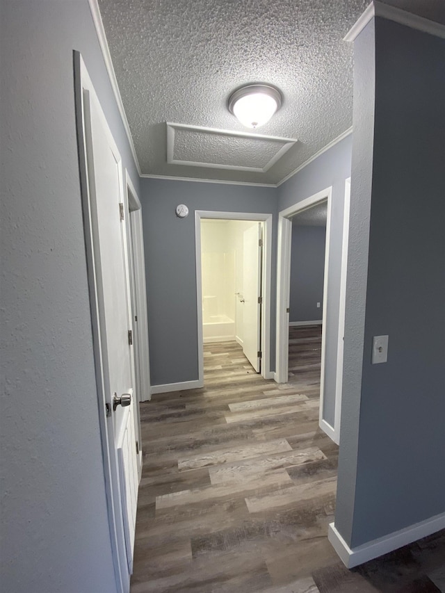 4350 Fortner Cir, Perry, FL 32347 - corridor with a textured ceiling, wood finished floors, ornamental molding, and attic access